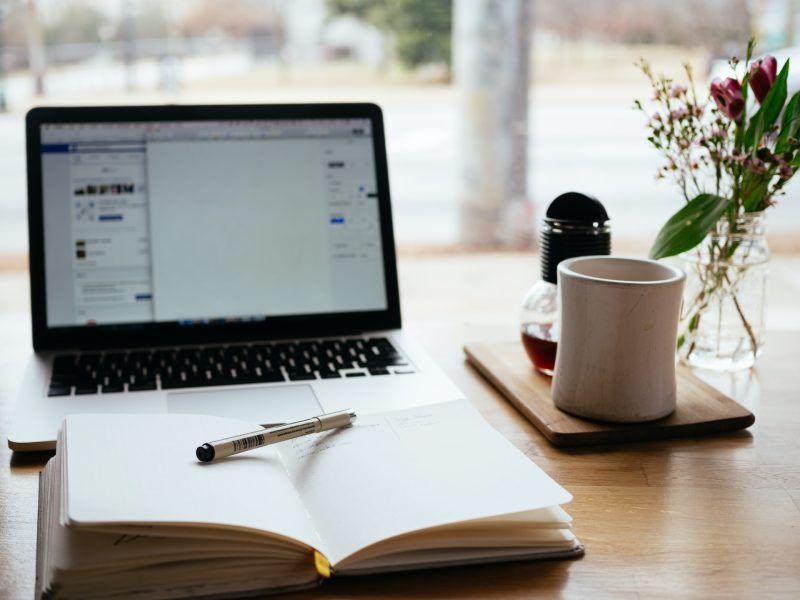 open book with a computer and coffee mug