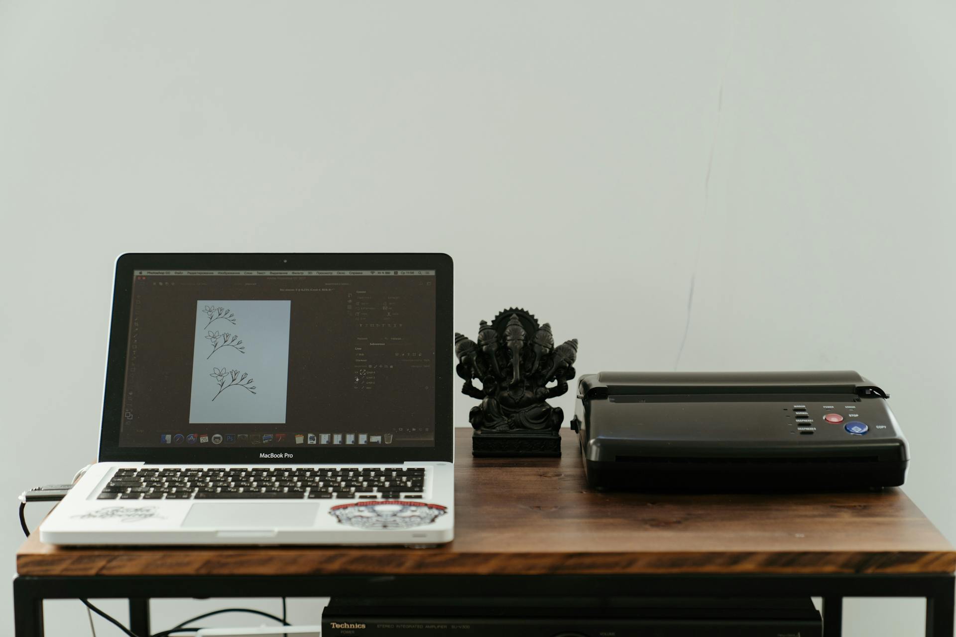 photo of a label printer on a wood table connected to laptop